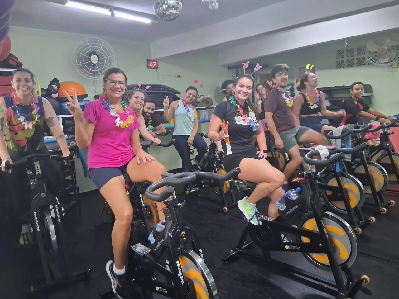 Alunos sorrindo durante a aula de bike indoor